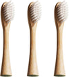 Three replacement brush heads with brown bamboo handles and white bristles