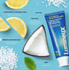 Lumineux toothpaste tube with lemon, coconut, and sea salt on a blue background